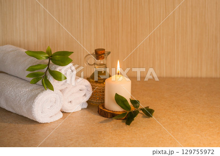 Spa, beauty and wellness background. Minimal concept. Towel, leaf and candle Spa, beauty and wellness background. Minimal concept. Towel, leaf and candle 129755972