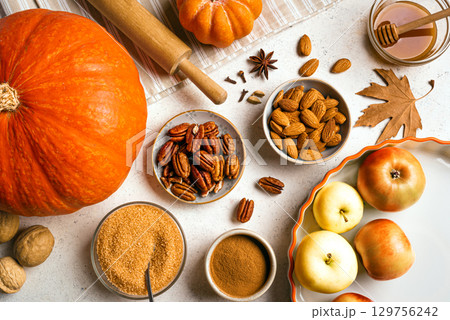 Autumn fall baking background with pumpkins, apples and ingredients 129756242