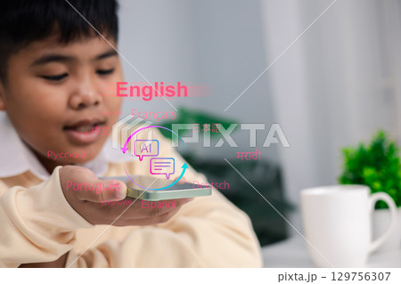 Boy using smartphone with AI language translation hologram for multilingual learning, communication, education technology, artificial intelligence, and future digital innovation. 129756307