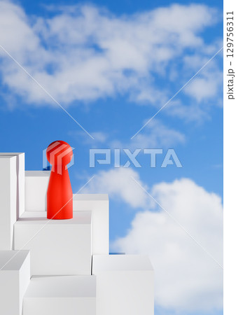 leadership, career advancement, success, and personal growth. 3D render of a red abstract pawn figure standing on top of a white block staircase against a vibrant blue sky with clouds. 129756311