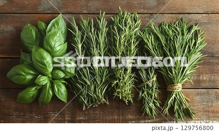 Fresh culinary herbs basil rosemary thyme on rustic wood 129756800