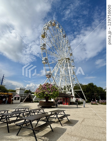 Ferris wheel on the background of blue sky in summer. High quality photo Ferris wheel on the background of blue sky in summer. High quality photo 129758600