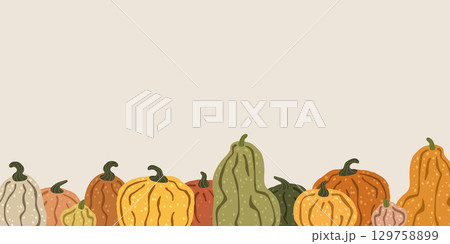 Colorful pumpkins forming a seamless border on a beige background 129758899