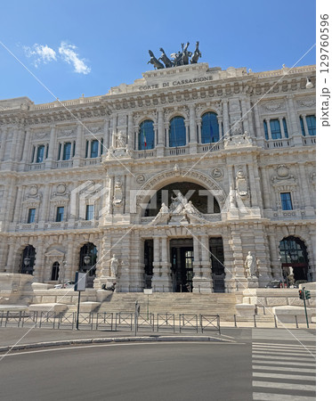 The majestic Palace of Justice in Rome, Italy (CORTE DI CASSAZIONE). Facade view features intricate carvings, statues, and a prominent archway with a wide staircase leads to the main entrance 129760596