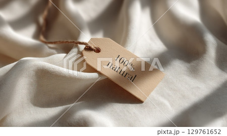Close-Up of Eco-Friendly Label on Soft Beige Organic Fabric Close-Up of Eco-Friendly Label on Soft Beige Organic Fabric 129761652