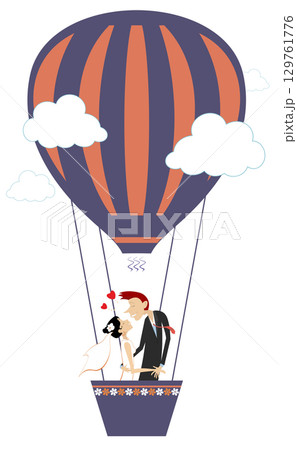 Married wedding couple flying up on the air balloon. Heart symbol and kissing married wedding couple fly up on the air balloon. Wedding ceremony. 129761776