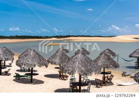 Straw huts on the banks of the Torta Lagoon, Tatajuba Beach at Jijoca de Jericoacoara, Ceara in Brazil 129762264