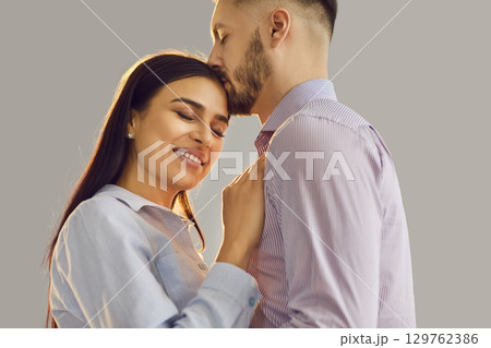 Loving romantic couple care, man and woman hugging, standing close together to at each other Loving romantic couple care, man and woman hugging, standing close together to at each other 129762386