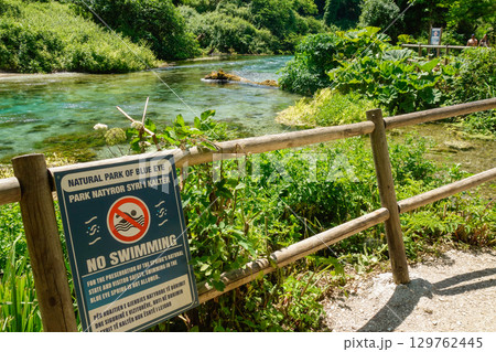 NO SWIMMING sign at Blue Eye Nature Monument near to Saranda, Albania NO SWIMMING sign at Blue Eye Nature Monument near to Saranda, Albania 129762445