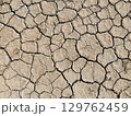 Cracked Drought Soil Texture - Dry Earth Background from Desert Environment 129762459