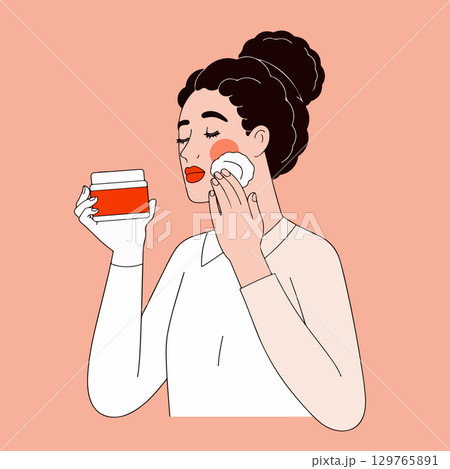 Woman Cleansing Face with Cotton Pad 129765891