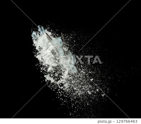 Nail spike Nut bold sharp object under snow on road. Dangerous sharpen nail glass object hidden in snow. Snow fall with risk accident hazard cover trash garbage debris. Black background isolated 129766463