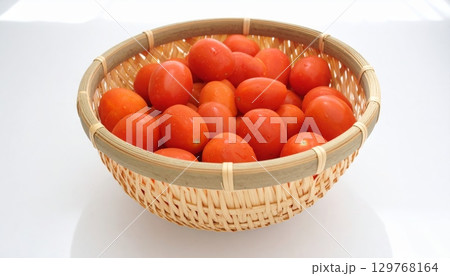 A fresh basket of juicy red strawberries, ripe apples, and organic tomatoes A fresh basket of juicy red strawberries, ripe apples, and organic tomatoes 129768164