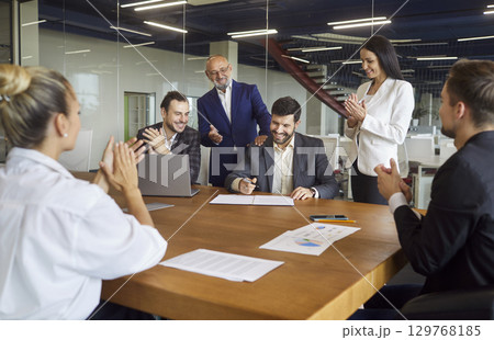 Business people sitting together at table with papers, making project, discussing sale statistics Business people sitting together at table with papers, making project, discussing sale statistics 129768185