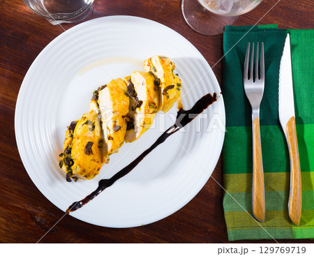 Turkey breast with prunes on plate Turkey breast with prunes on plate 129769719