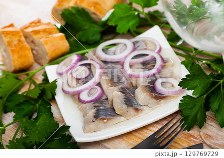 Salted herring fillet with onion Salted herring fillet with onion 129769729