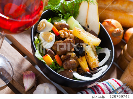 Salad from chicken hearts with peach, pear, quail eggs and grilled cheese Salad from chicken hearts with peach, pear, quail eggs and grilled cheese 129769742