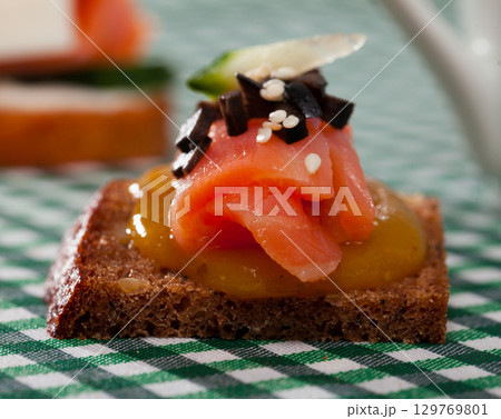 Canape with salmon and mango sauce Canape with salmon and mango sauce 129769801