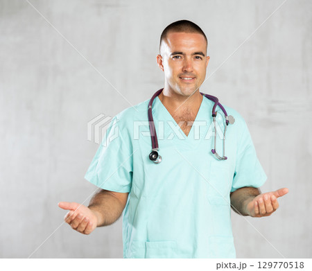 Portrait of male health worker meeting patient in medical office 129770518