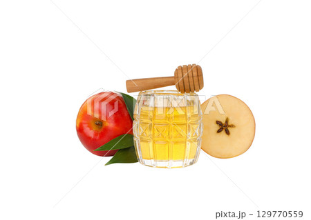 Glass jar filled with honey beside fresh apples, isolated on white, PNG 129770559