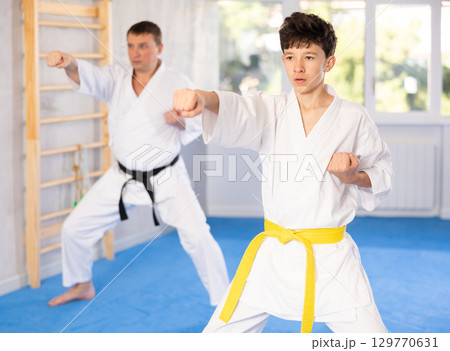 Man and boy teenager train karate technique Man and boy teenager train karate technique 129770631