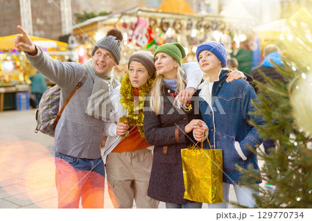 Portrait of family visiting Christmas street fair Portrait of family visiting Christmas street fair 129770734
