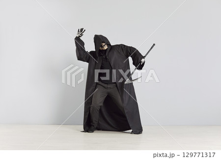 Grim Reaper Dancing With Scythe At Halloween Party On Grey Background Grim Reaper Dancing With Scythe At Halloween Party On Grey Background 129771317