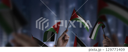Palestine flags in their hands on a blurred urban background 129771409