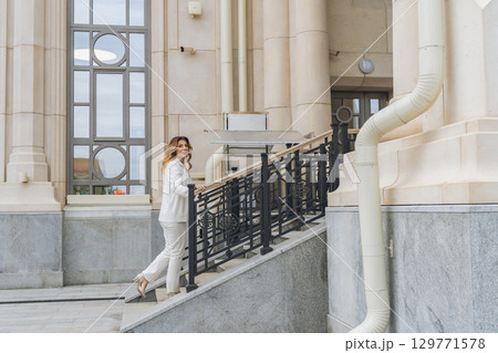 Woman White Suit Stairs Building Entrance 129771578