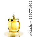 Luxurious golden glass jar with a luxurious design, set against a backdrop of shiny gold and soft lighting 129771602
