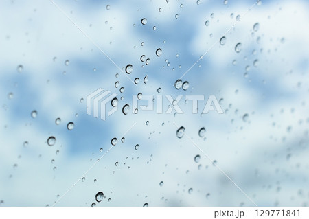 water drop on mirror with blue sky and white cloud background water drop on mirror with blue sky and white cloud background 129771841