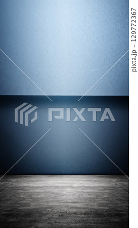 Interior of a modern and minimalist studio with a blue wall and dark floor background. Mockup or copy space 129772367