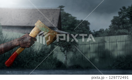 Zombie hands with a bloody wound holding an axe with a night scene background. Zombie, devil, evil, satan, or monster hands. The scene is dark and scary. Concept of Spooky Halloween 129772491