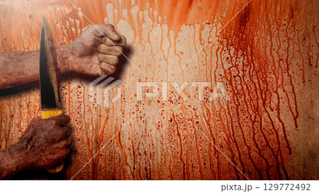 Zombie hand with a bloody wound holding the knife with blood splashes on the wall background. A zombie hand swings the knife to the wrist, creating a tense and scary scene. Concept of Spooky Halloween 129772492