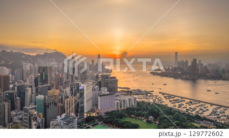 Aug 8 2025 Victoria Harbour glowing under vibrant sunset sky 129772602
