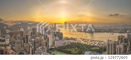Aug 8 2025 Victoria Harbour glowing under vibrant sunset sky 129772605