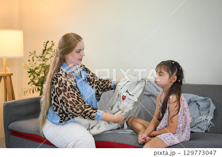 Child with a displeased expression avoids school preparations, expressing reluctance and resistance 129773047