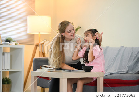 Parent supporting child learning and development through homework help Parent supporting child learning and development through homework help 129773063
