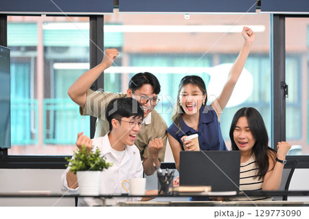 Excited business team celebrating victory or successful project results together in an office Excited business team celebrating victory or successful project results together in an office 129773090