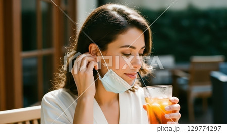 Woman removing face mask to drink iced tea at...のイラスト素材 [129774297] - PIXTA