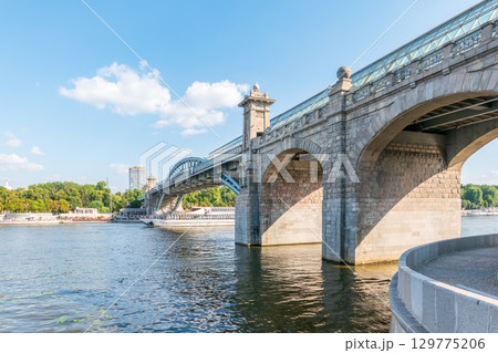 View of the Moscow river embankment, Pushkinsky bridge and cruise ships at sunset. 129775206