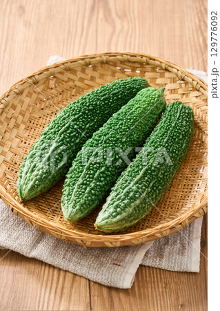 ゴーヤ|沖縄の夏野菜を竹ざるに盛った食材イメージ ゴーヤ|沖縄の夏野菜を竹ざるに盛った食材イメージ 129776092