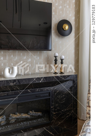 Modern Fireplace with TV and Stylish Decor Accents 129779183