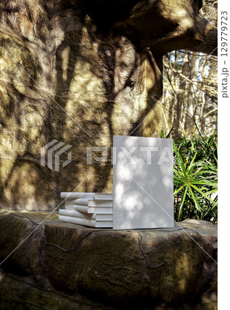 Book mockup on natural stone background outdoors, blank cover for design, branding, education, storytelling, creativity, and inspirational concepts Book mockup on natural stone background outdoors, blank cover for design, branding, education, storytelling, creativity, and inspirational concepts 129779723