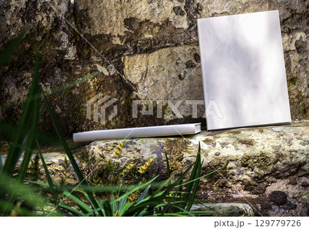 Book mockup on natural stone background outdoors, blank cover for design, branding, education, storytelling, creativity, and inspirational concepts 129779726