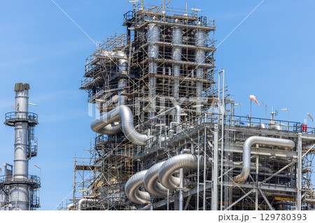 Oil and Gas refinery petrochemical plant industrial on blue sky background, Oil and Gas refinery petrochemical plant pipeline steel, Oil and Gas refinery factory maintenance, Global energy refinery. Oil and Gas refinery petrochemical plant industrial on blue sky background, Oil and Gas refinery petrochemical plant pipeline steel, Oil and Gas refinery factory maintenance, Global energy refinery. 129780393