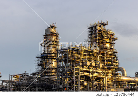 Oil and Gas refinery petrochemical plant industrial on sunset background, Oil and Gas refinery petrochemical plant pipeline steel, Oil and Gas refinery factory maintenance, Global energy refinery. Oil and Gas refinery petrochemical plant industrial on sunset background, Oil and Gas refinery petrochemical plant pipeline steel, Oil and Gas refinery factory maintenance, Global energy refinery. 129780444