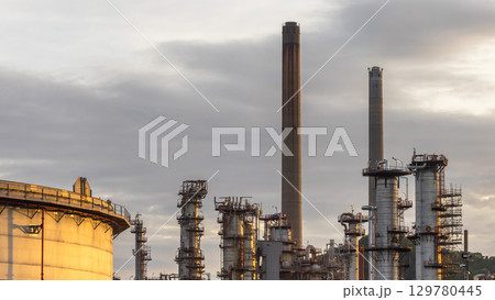 Oil and Gas refinery petrochemical plant industrial on sunset background, Oil and Gas refinery petrochemical plant pipeline steel, Oil and Gas refinery factory maintenance, Global energy refinery. Oil and Gas refinery petrochemical plant industrial on sunset background, Oil and Gas refinery petrochemical plant pipeline steel, Oil and Gas refinery factory maintenance, Global energy refinery. 129780445