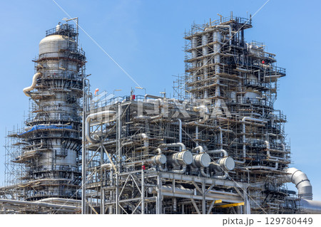 Oil and Gas refinery petrochemical plant industrial on blue sky background, Oil and Gas refinery petrochemical plant pipeline steel, Oil and Gas refinery factory maintenance, Global energy refinery. 129780449