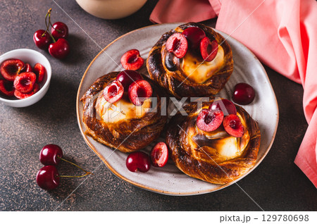 Homemade cherry cheesecakes on a plate on the table 129780698